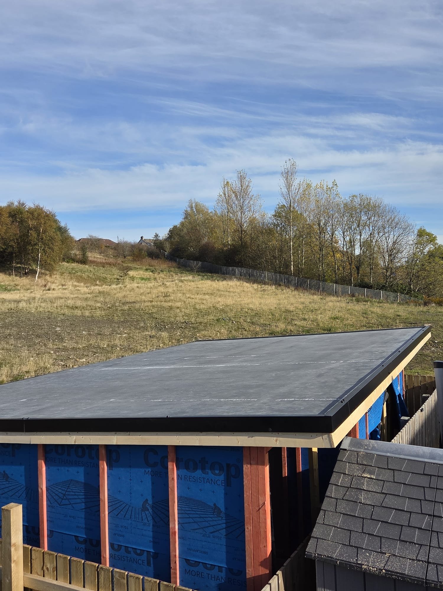 Completed Firestone EPDM rubber flat roof with black perimeter trims