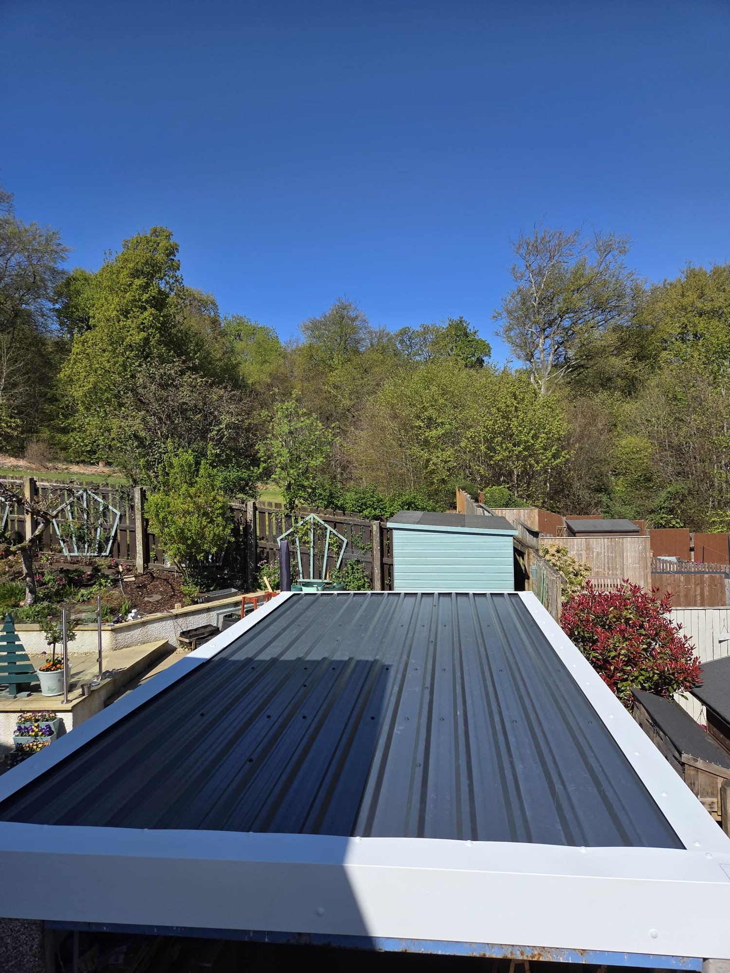 Completed grey garage roof with white trims in Glasgow